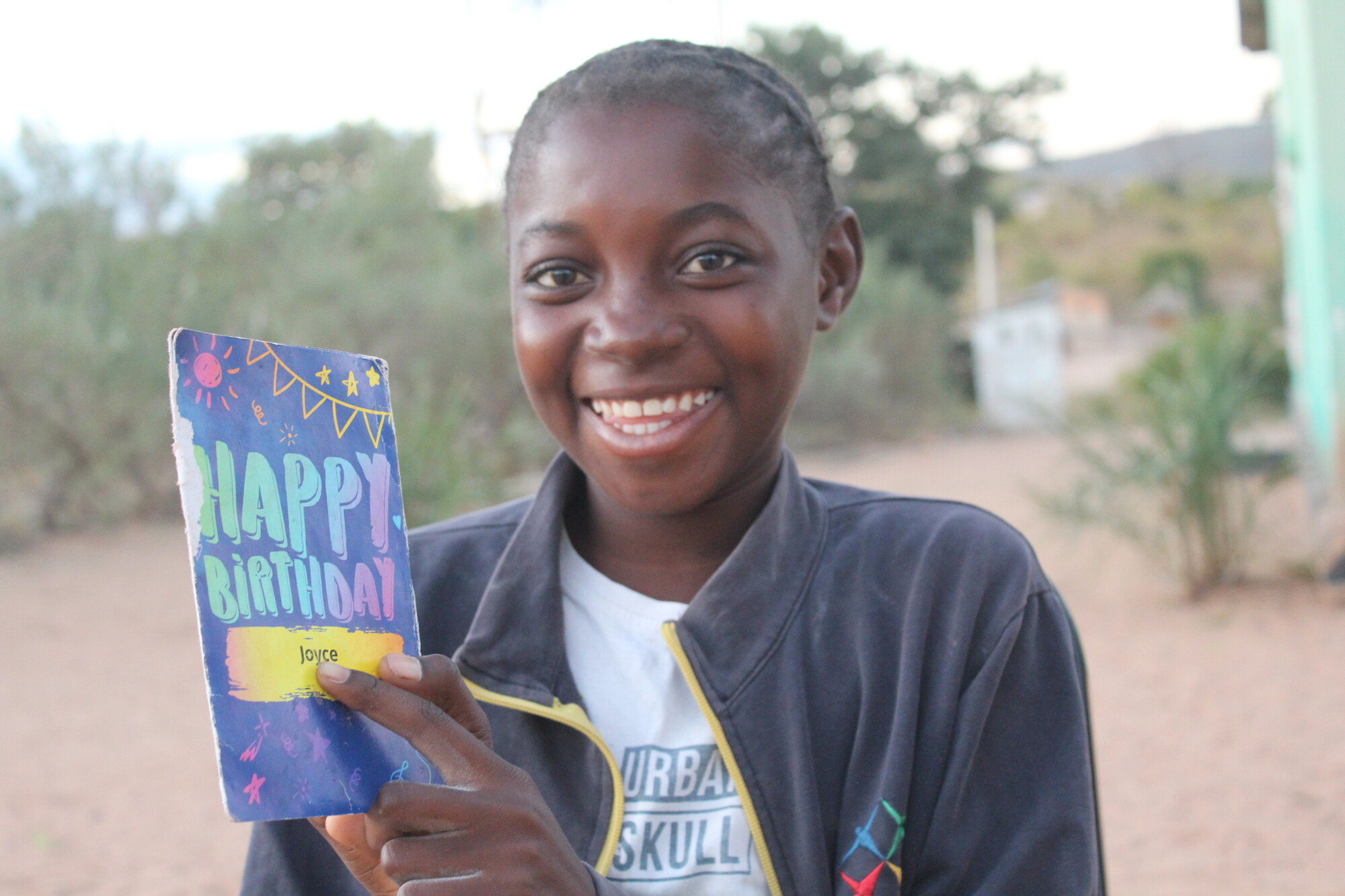 Birthday Card All smiles as a child receives a birthday card from her sponsor.