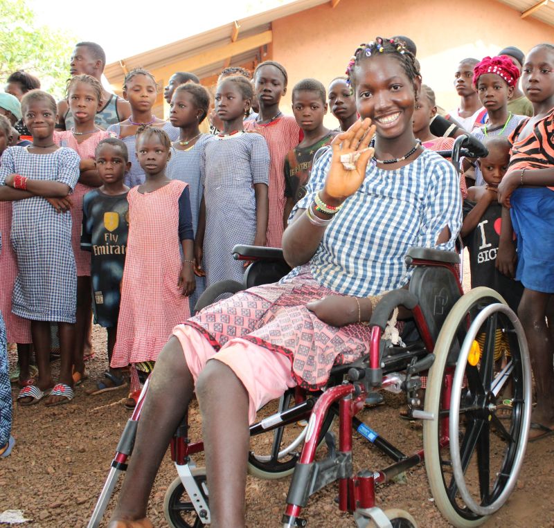 Tata Tata, 14, celebrates getting a new wheelchair from ChildFund after her family lost their possessions in a fire.